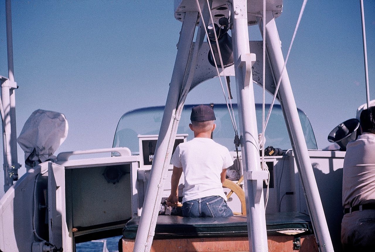 Steven T. Callan at the helm of the Fish and Game Patrol Boat Marlin