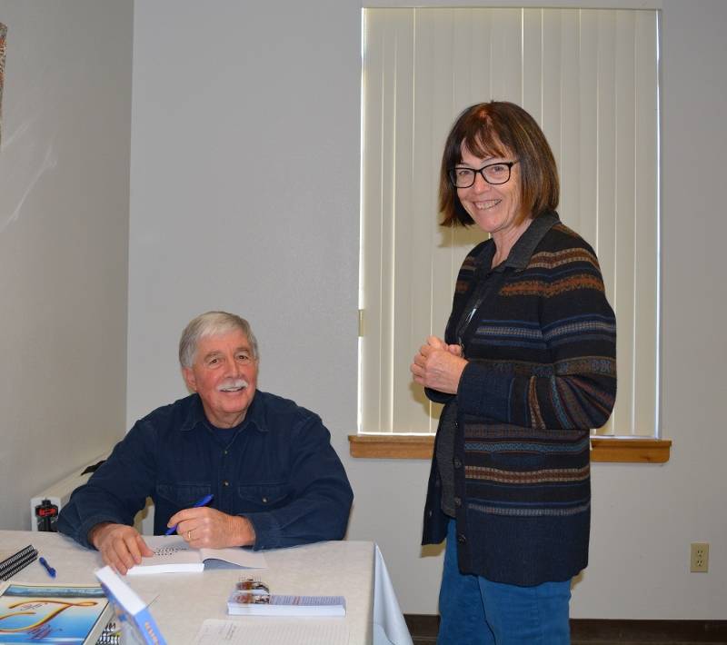 Steve signs a copy of his book The Game Warden's Son for a member of Redding Writers Forum.