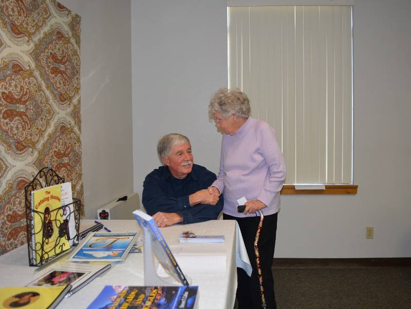 Author Steven T. Callan visits with a member of Redding Writers Forum during his visit to discuss his book The Game Warden's Son.