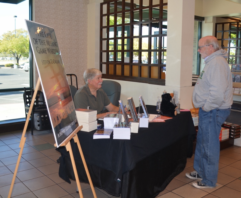 Author Steven T. Callan and friend discuss the author's latest book, The Case of the Missing Game Warden, at the Chico Barnes and Noble