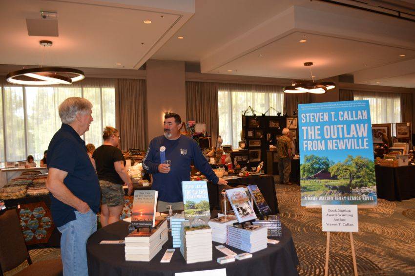 Author Steven T. Callan and friend at a book signing celebrating the release of The Outlaw from Newville, his second novel in the Game Warden Henry Glance series, at the Pacific Flyway Decoy Association Wildfowl Classic