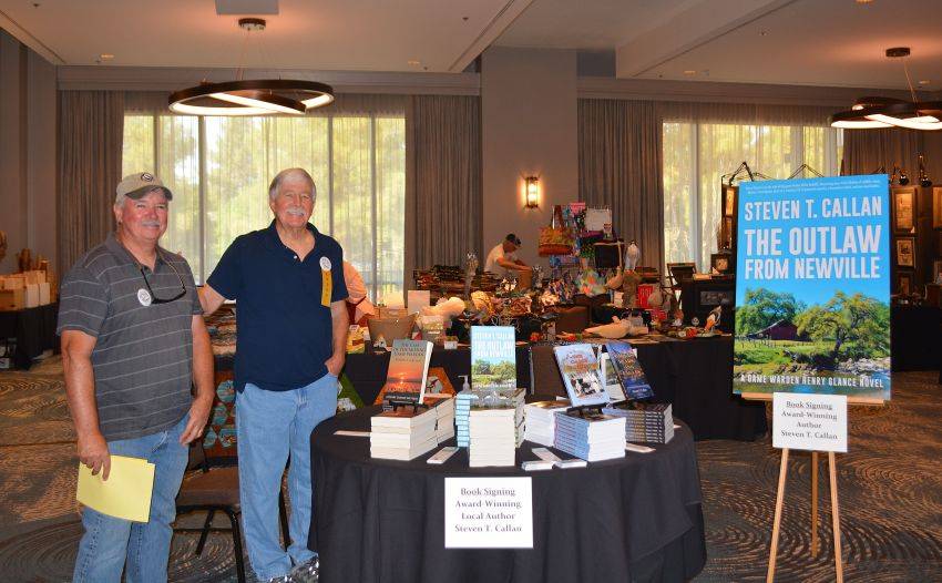 Author Steven T. Callan and friend at a book signing celebrating the release of The Outlaw from Newville, his second novel in the Game Warden Henry Glance series, at the Pacific Flyway Decoy Association Wildfowl Classic