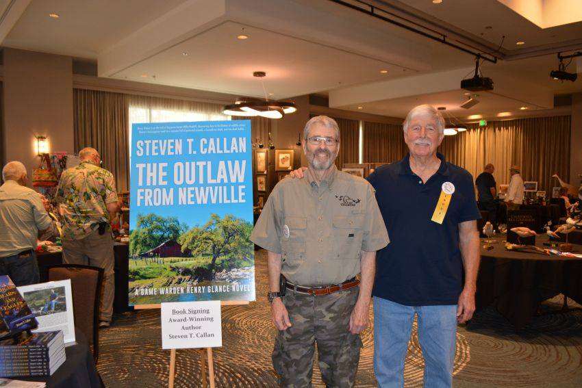 Author Steven T. Callan and friend at a book signing celebrating the release of The Outlaw from Newville, his second novel in the Game Warden Henry Glance series, at the Pacific Flyway Decoy Association Wildfowl Classic