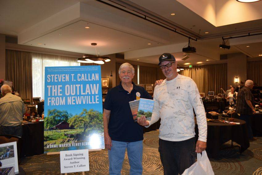 Author Steven T. Callan and friend at a book signing celebrating the release of The Outlaw from Newville, his second novel in the Game Warden Henry Glance series, at the Pacific Flyway Decoy Association Wildfowl Classic