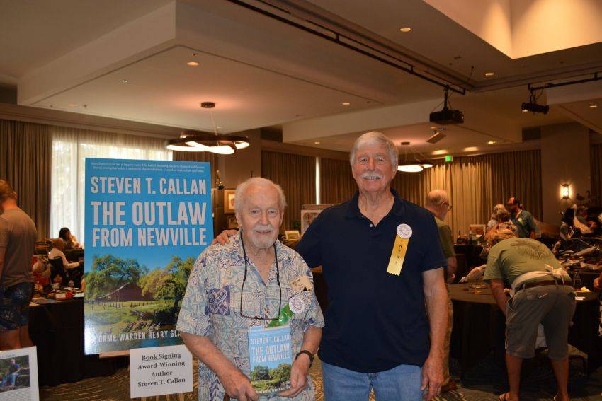 Author Steven T. Callan and friend at a book signing celebrating the release of The Outlaw from Newville, his second novel in the Game Warden Henry Glance series, at the Pacific Flyway Decoy Association Wildfowl Classic
