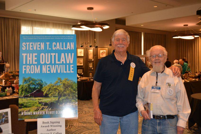 Author Steven T. Callan and friend at a book signing celebrating the release of The Outlaw from Newville, his second novel in the Game Warden Henry Glance series, at the Pacific Flyway Decoy Association Wildfowl Classic