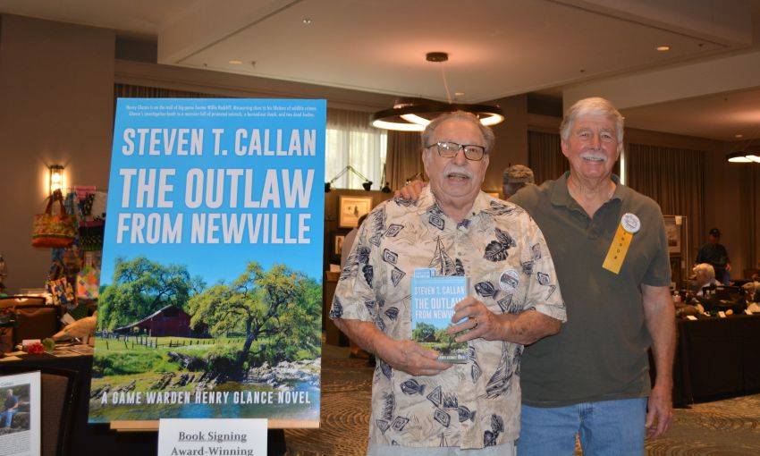 Author Steven T. Callan and friend at a book signing celebrating the release of The Outlaw from Newville, his second novel in the Game Warden Henry Glance series, at the Pacific Flyway Decoy Association Wildfowl Classic