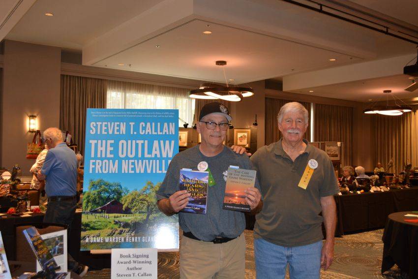 Author Steven T. Callan and friend at a book signing celebrating the release of The Outlaw from Newville, his second novel in the Game Warden Henry Glance series, at the Pacific Flyway Decoy Association Wildfowl Classic